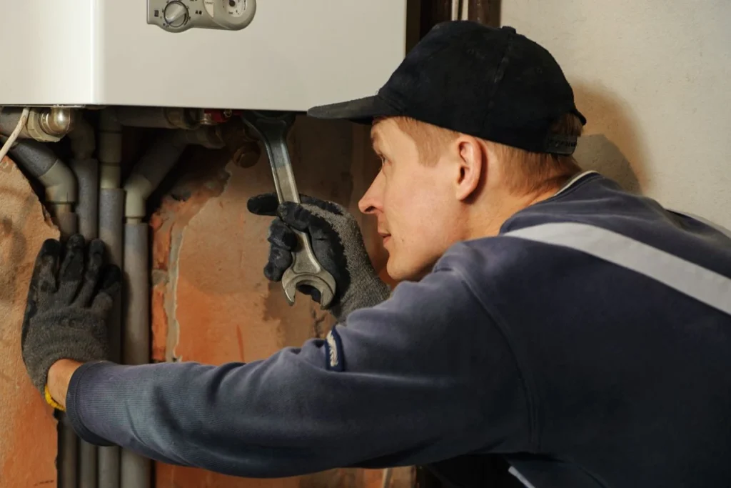 Technician inspecting a residential water heater