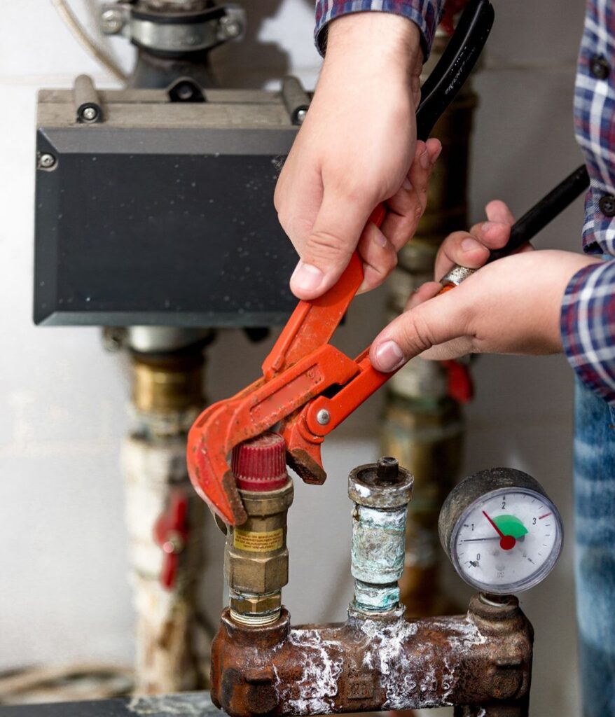 Professional plumber servicing a residential drain